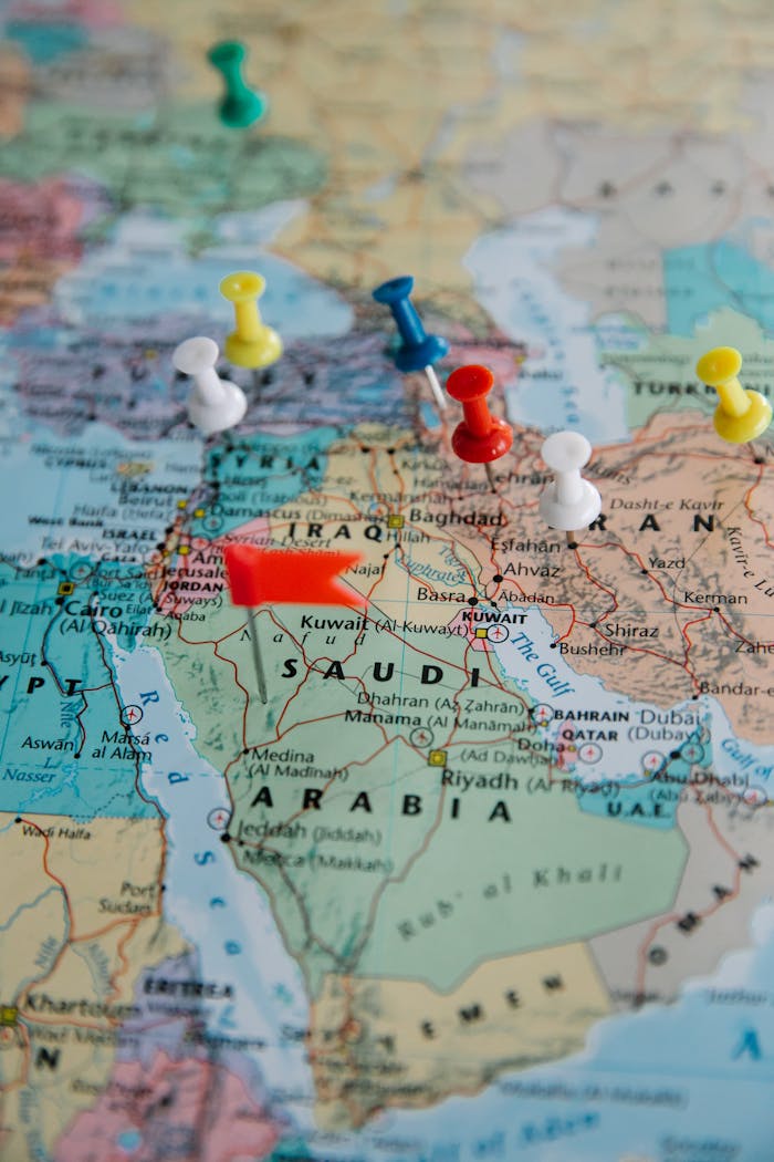 Colorful pushpins mark locations on a map of the Middle East, highlighting travel plans.